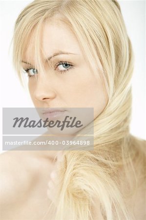 Portrait of Fresh and Beautiful young blond woman playing with her hair
