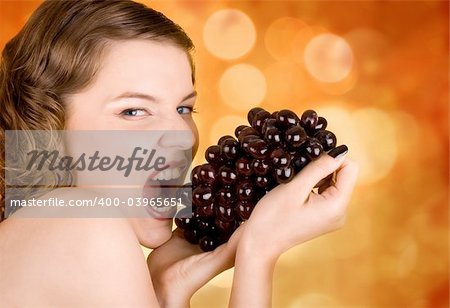 glamorous girl holding some grapes in her hand