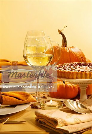 Festive table with candles and pumpkins ready for Thanksgiving