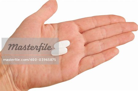 Two white pills on a hand isolated on white background