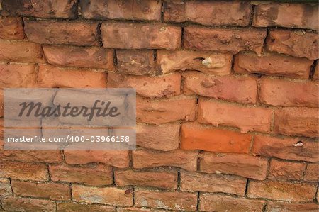 a brick wall with very well eroded bricks