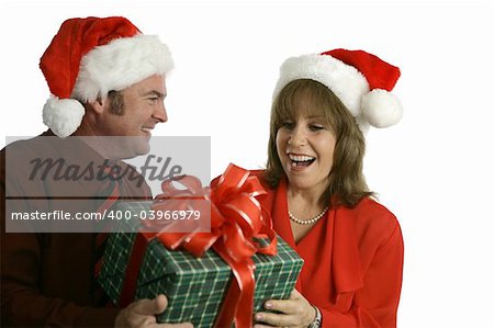 A man giving a woman a Christmas gift.  Isolated on white.