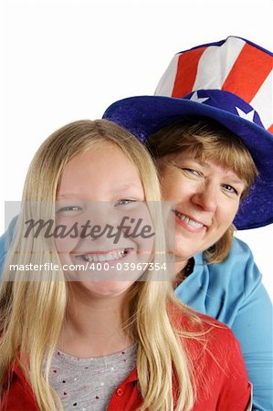 A cute american girl and her mother dressed for the Fourth of July holiday.  Isolated on white.