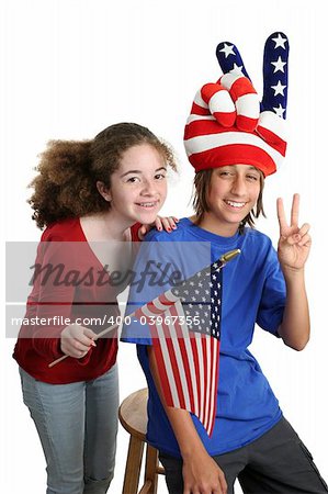 Two teens celebrating American Independence Day with patriotic hat and US flag.  Isolated.