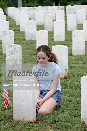 a young girl mourning a fallen soldier in a graveyard