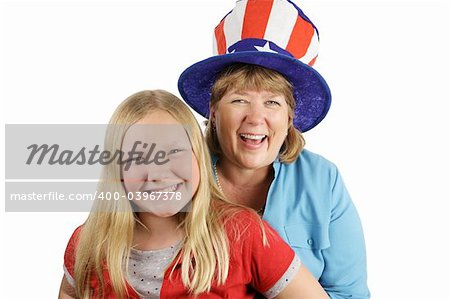 A mother and daughter dressed for fourth of july.  The focus is on the mother in the hat, laughing.  Isolated on white.