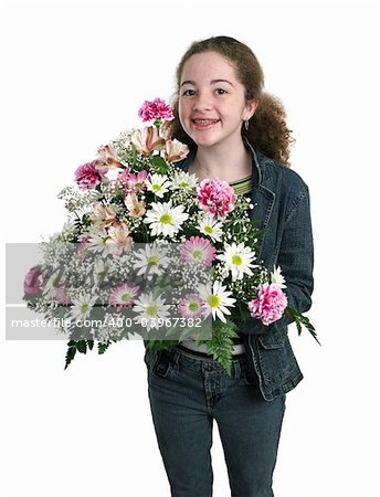 A happy teen girl holding a big bouquet of flowers.  Isolated.