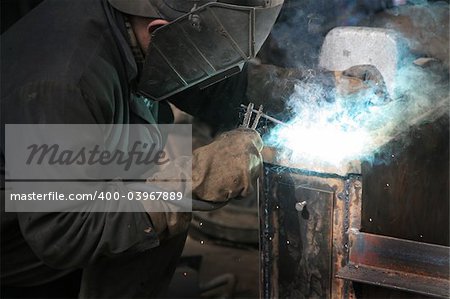 The welder behind work at a modern factory