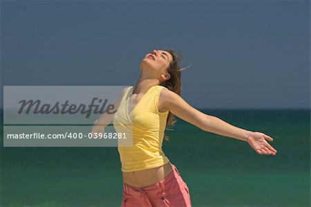 Beautiful woman making poses in the beach