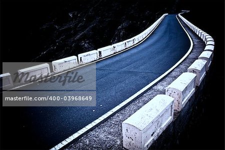 Lonely winding road, dramatic colors & light.