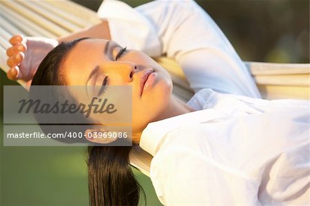 20-25 years woman portrait ralaxing on hammock at exotic surrounding, bali indonesia