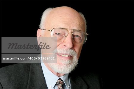 A friendly senior man against a black background.