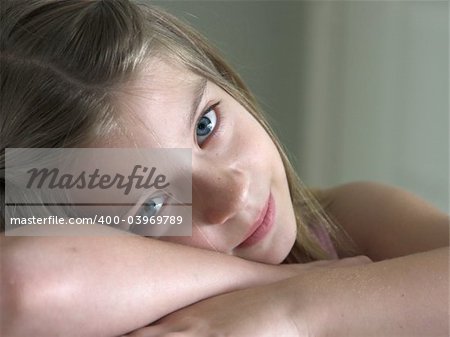 a pretty little girl resting her head on her hands