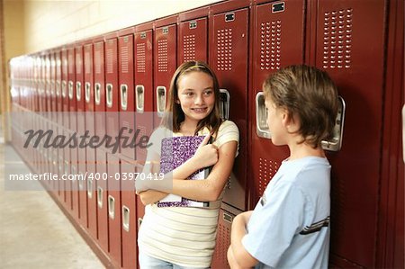 A cute school girl talking to a boy outside her locker.  Lockers are textured.  May appear as noise or artifacts at 100%.