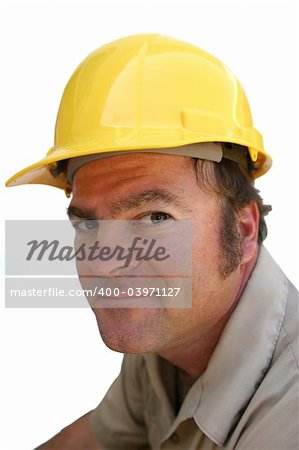 A repairman in a hard hat looking like he has bad news or like he is going to cheat you.