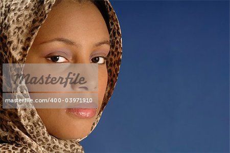 a woman in scarf against blue