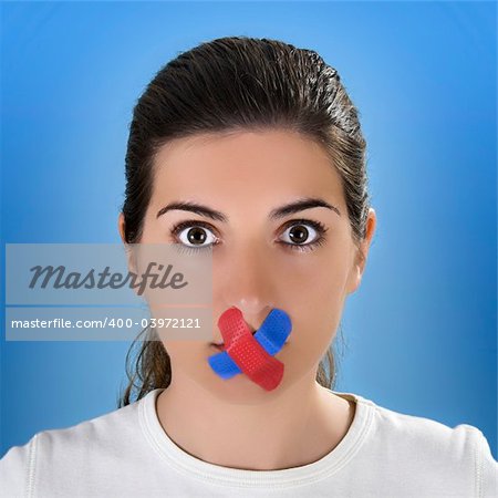 Beautiful woman with a colored cross bandage on the mouth