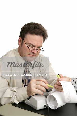 A man going over his accounts using a highlighter to identify issues.  Isolated on white.