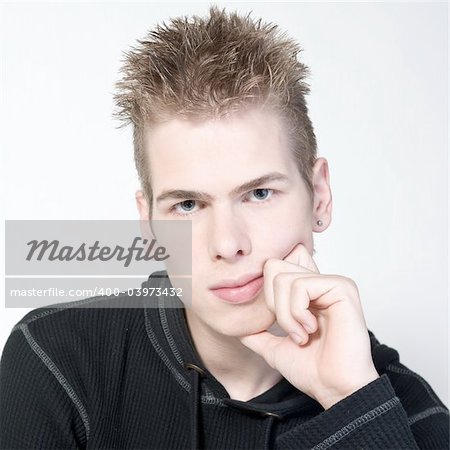 studio portrait of a thinking young man