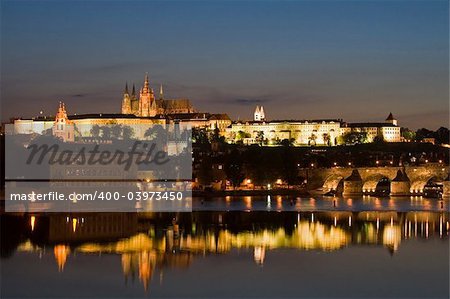 Charles bridge and the castle at night in Prague.