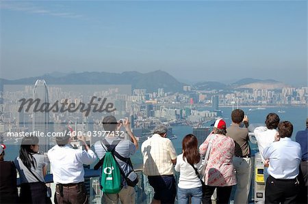 Tourists sightseeing the Hong Kong skyline at the Peak