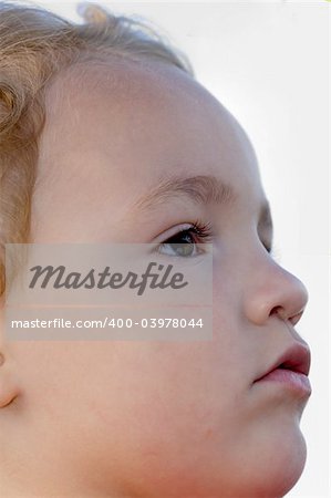 Young boy head shot while looking up in serious stare