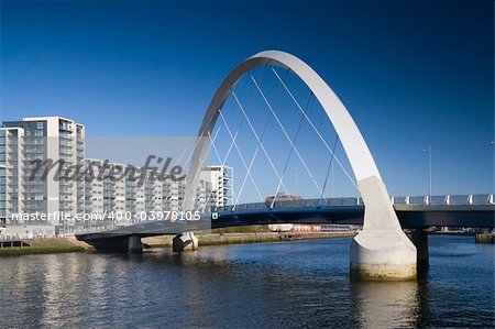The supporting arch of the Clyde Arc bridge in Glasgow, Scotland, against a blue sky