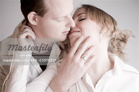 Studio portrait of a young amorous couple kissing