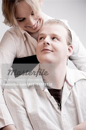 Studio portrait of a young amorous couple making eye contact with eachother