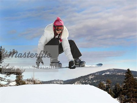 Young mexican girl jumping on a snowboard