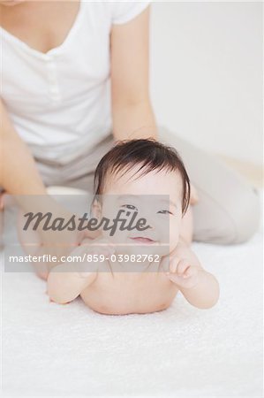 Mother Massaging Baby Girl