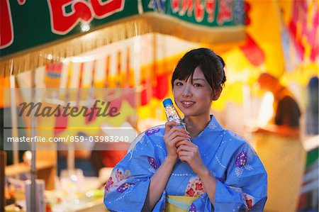 Young Japanese Woman Wearing Yukata At Matsuri