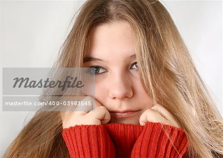 Portrait of a sad expression young woman with red pullover