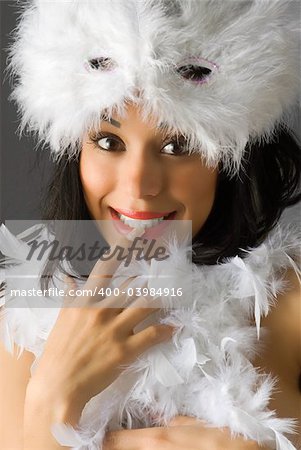 nice brunette with white feather mask and red lips making face