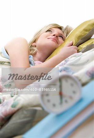 sleepy woman shuts off  alarm clock