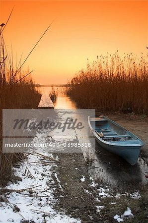 Fishing boat in the freezing lake