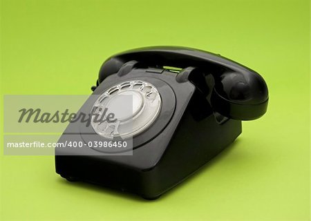 Vintage phone in a green background