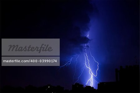 Lightning bolt over the city at the night