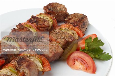 kebab served with grilled vegetables on white plate, selective focus