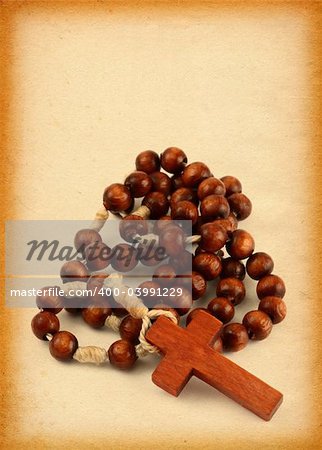 close-up of wooden rosary against old paper page