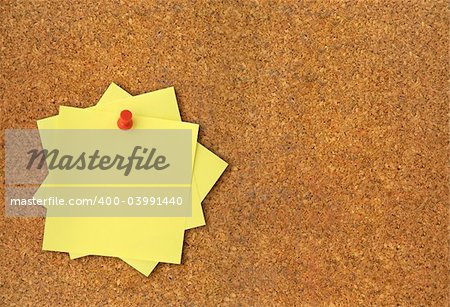 close-up of corkboard and blank adhesive notes