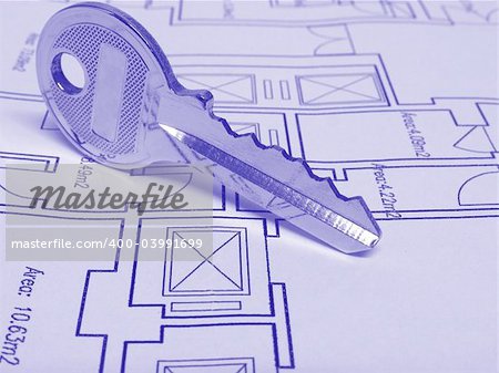 Architecture and real estate concept: House key on a house plan (Blue tone)