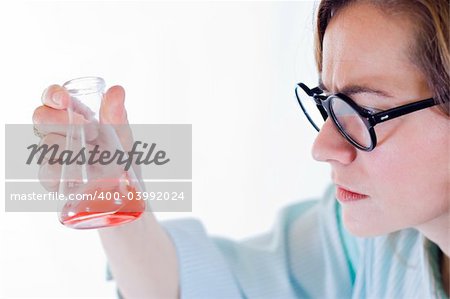 Scientist woman analyzing chemical material in Erlenmeyer flask