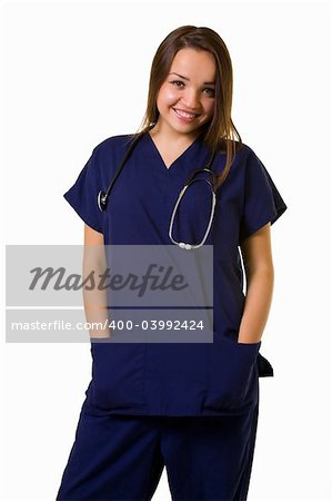 Pretty young woman healthcare worker wearing blue scrubs and a stethoscope standing on white with hands in pocket