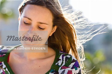 Woman smiling with hair flying on the wind.