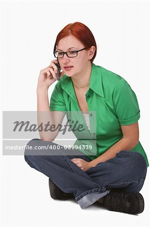 Image of a redheaded teenager girl using a mobile phone.Shot with Canon 70-200mm f/2.8L IS USM