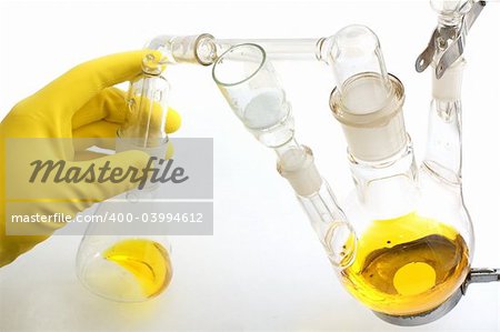 chemical equipment and a hand in yellow glove, isolated on white