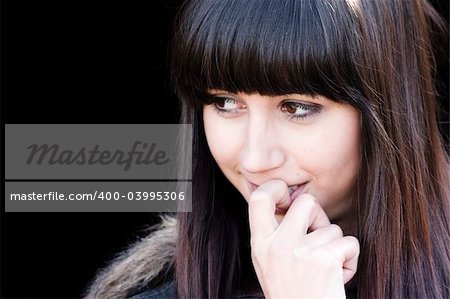 Closeup girl portrait against black background