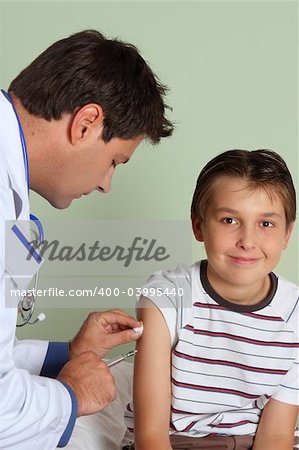 A doctor gives a child a vaccine or flu shot in the arm.