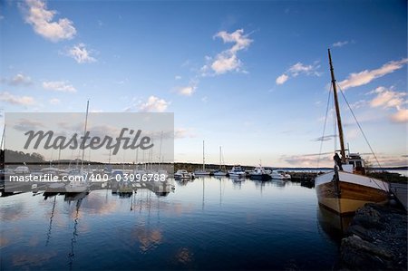 A dock with sailboats in the evening sun